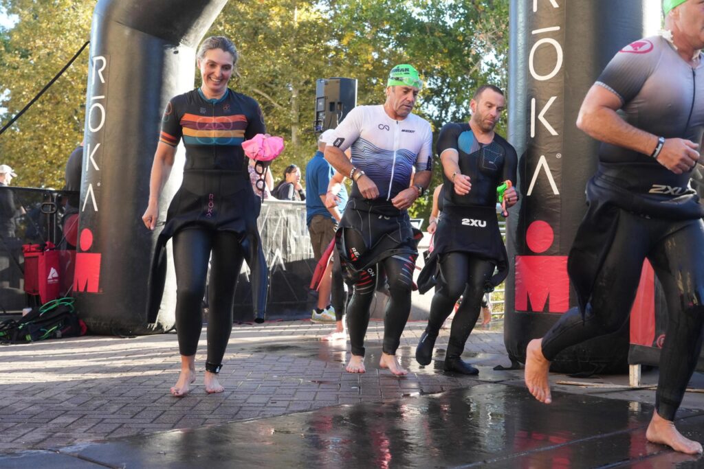 Ironman California 2025 barefoot transition from swimming to biking competition